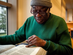 Langston Sylvester reads about Elijah Muhammad in The African American Almanac at the Sacramento Public Library. Sylvester visited the library each day during Black History Month to study the lives of notable African Americans.